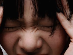 Close-up of a young woman with a frustrated expression, reflecting the stress of navigating ADHD treatment challenges