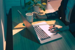ADHD psychiatric provider working on laptop in home office, representing neurodivergent-friendly mental health care.