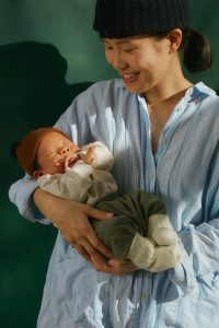 New mom holding her baby in Atlanta during the postpartum period